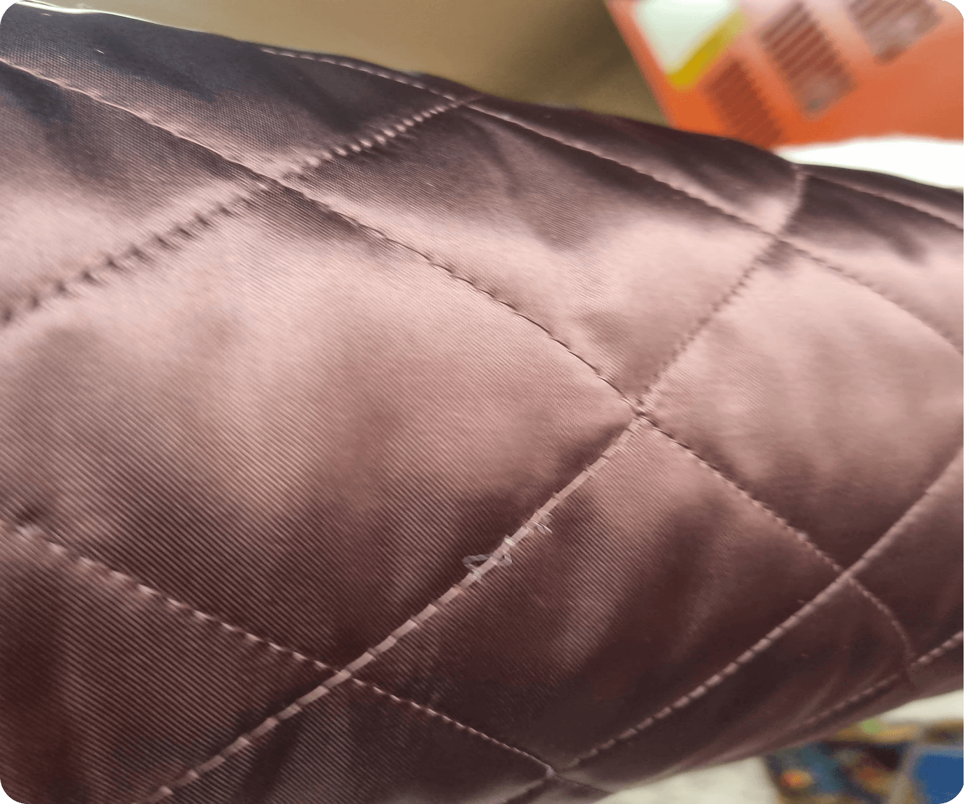 Close-up of dark brown box-quilted lining fabric