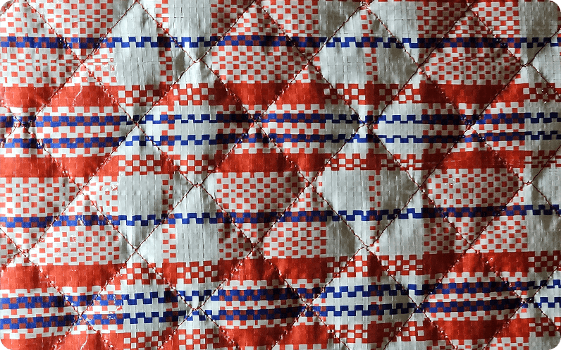 A hexagon pattern quilted in white cotton