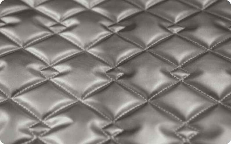 Silver satin quilted in a diamond pattern