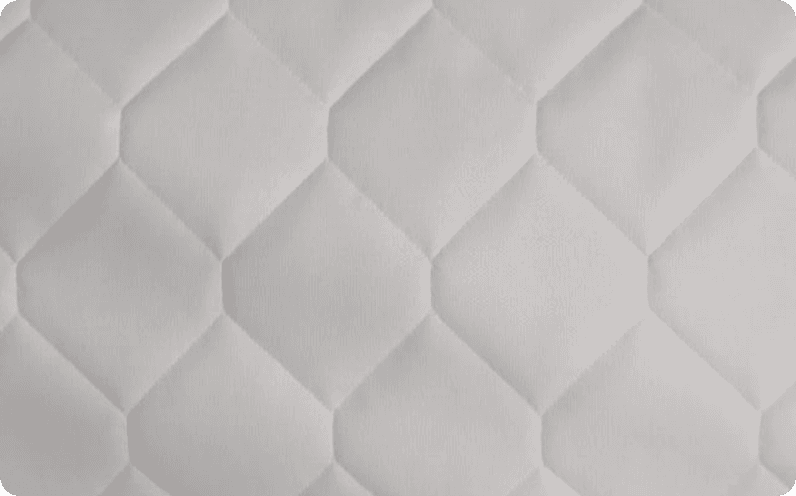 White fabric quilted in a hexagon pattern