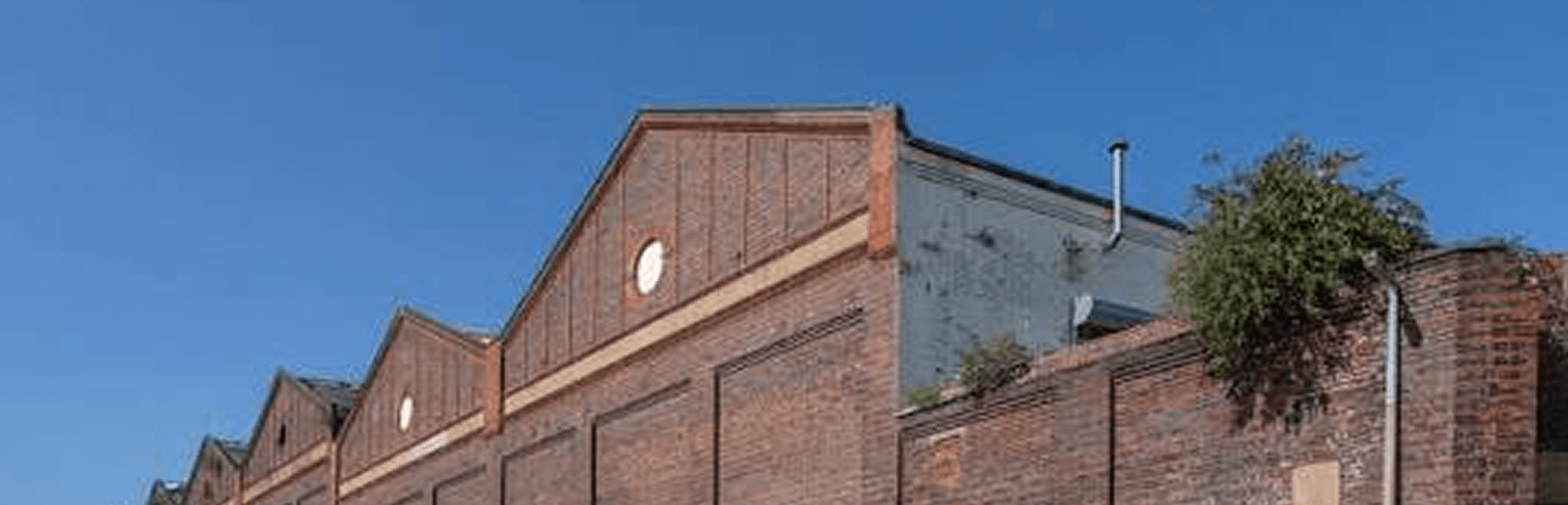 The brick sawtooth roofline of our West Midlands factory