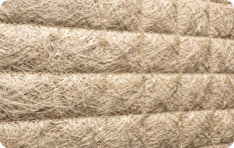 Close-up of coarse fibreglass wadding quilted in horizontal lines