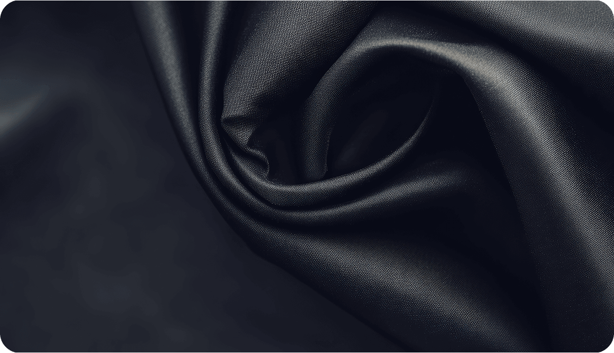 Folds of dark charcoal satin fabric