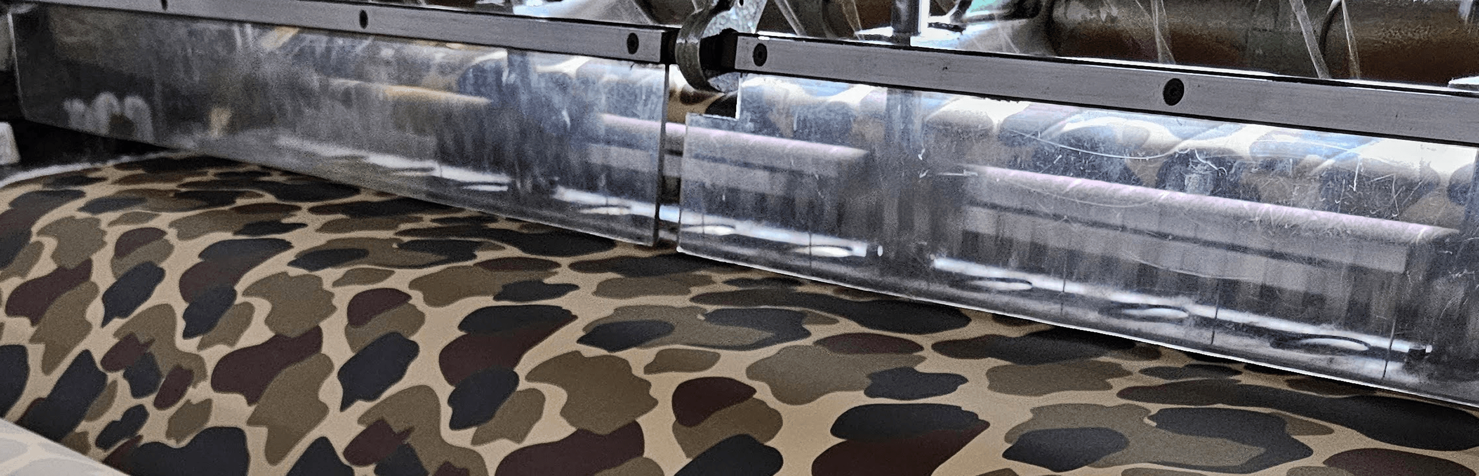 Quilted fabric running under the needle bar of a long-arm machine