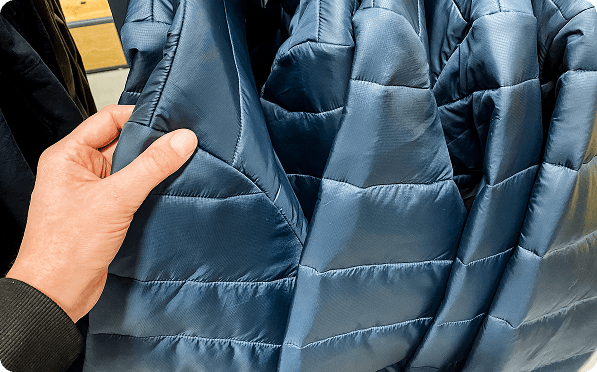 Navy quilted jackets on a rail