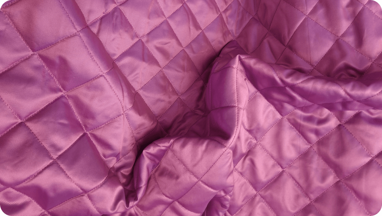 Folds of pink diamond-quilted fabric