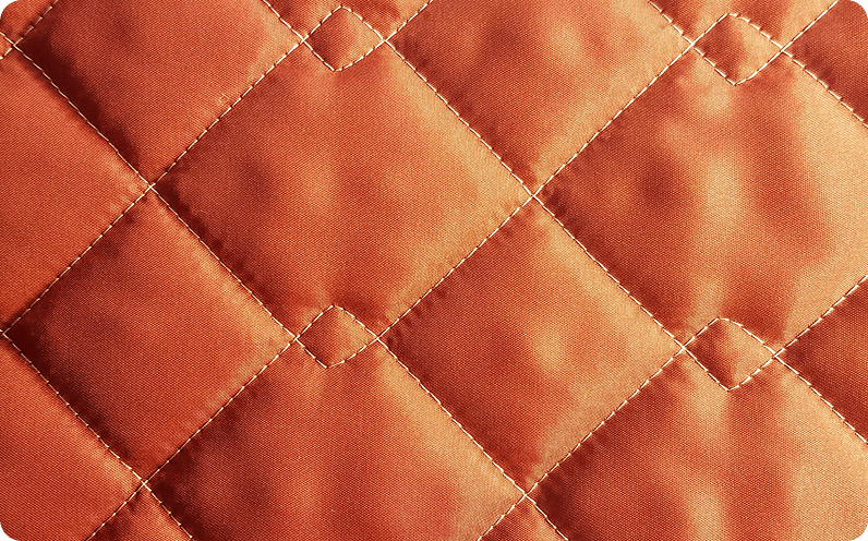 Orange fabric quilted in a diamond pattern