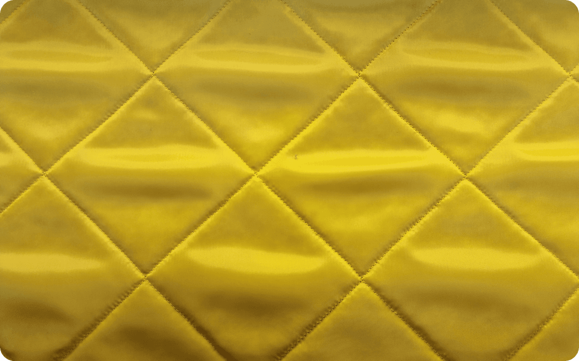 Yellow fabric quilted in a diamond pattern