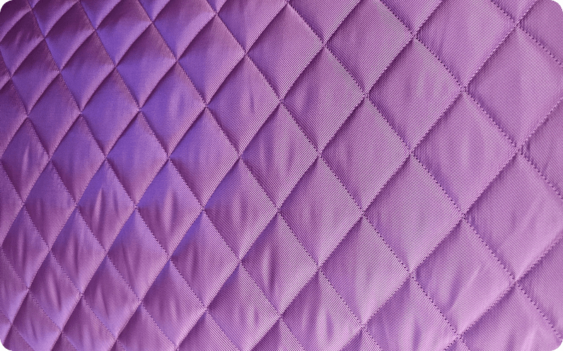 Purple fabric quilted in a diamond pattern