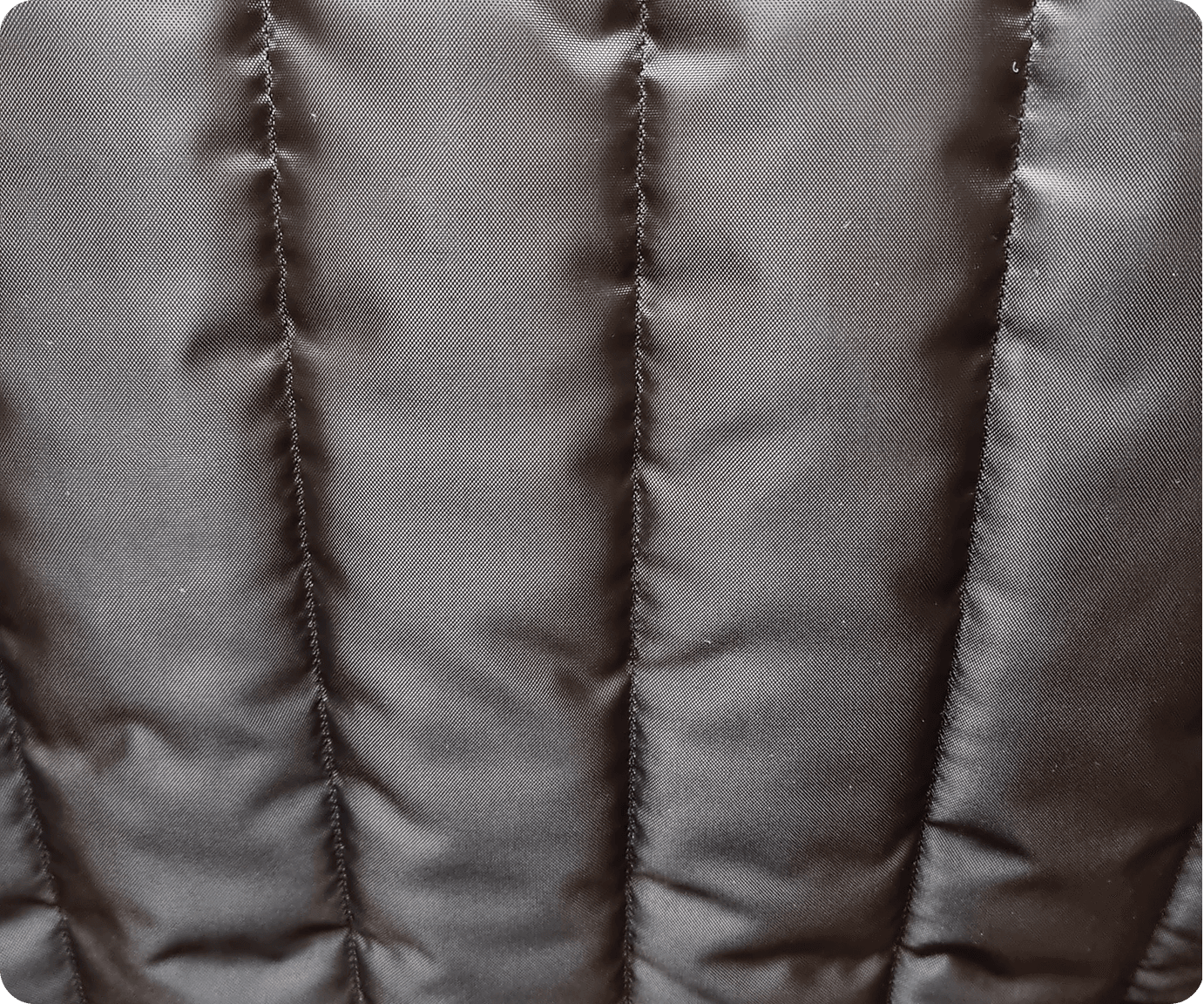 Close-up of dark brown channel-quilted lining fabric
