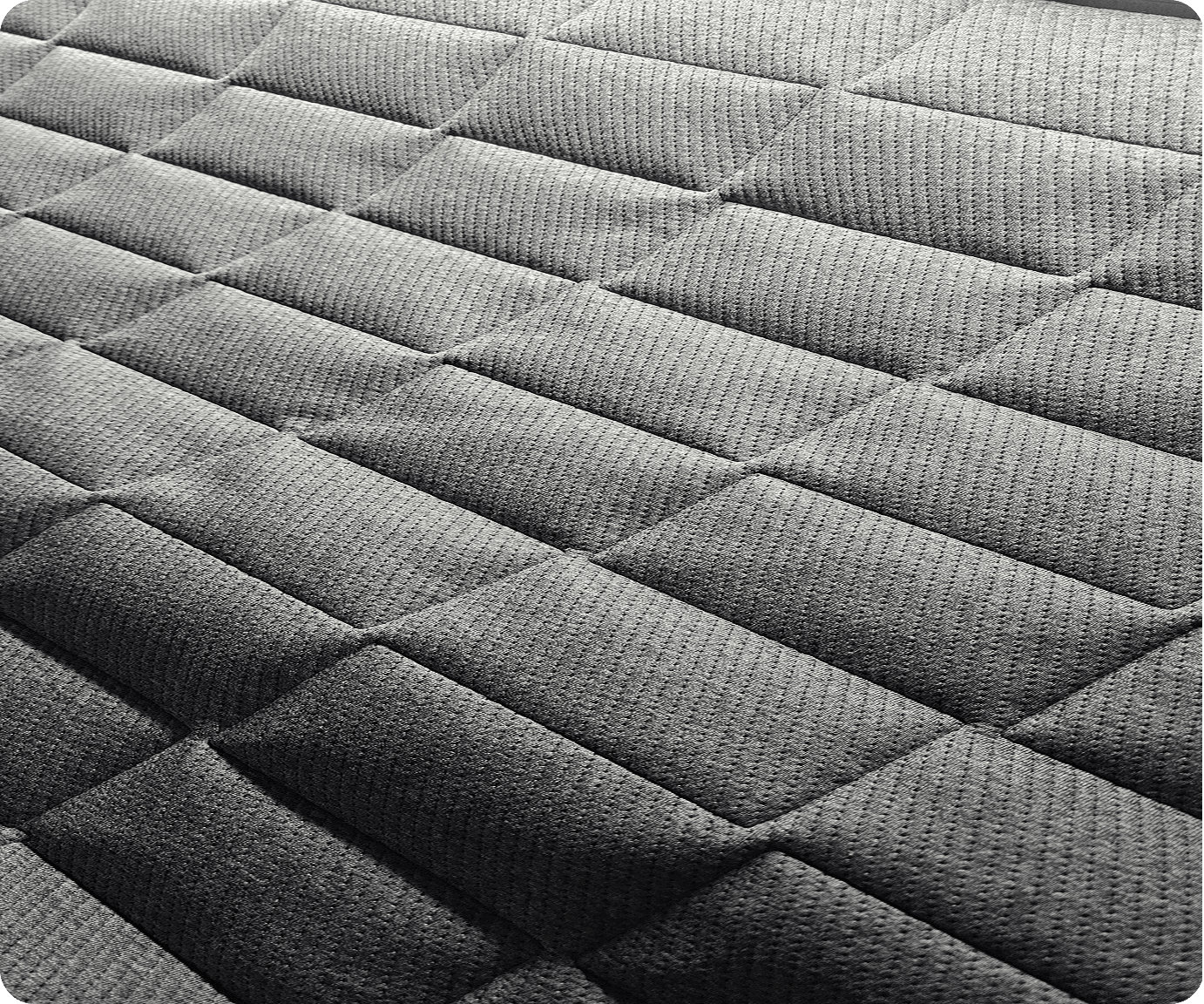 Close-up of grey box-quilted textured fabric