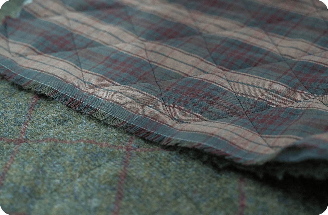 Quilted tartan fabric with a raw edge