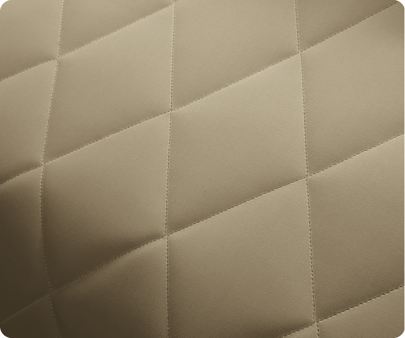 Close-up of beige diamond-quilted upholstery fabric
